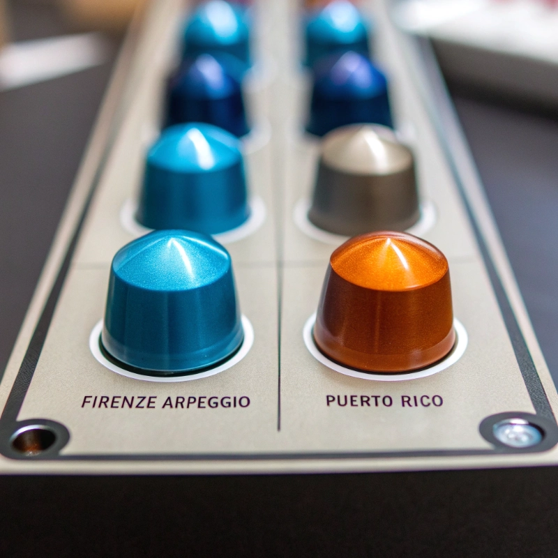 Close-up of ranked capsules like Firenze Arpeggio and Puerto Rico, showcasing color-coded intensities